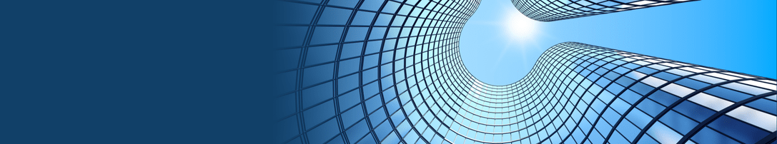 a photo looking up at a swooping, curving building made of glass windows